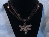 Copper Dragonfly Necklace
Over 100 Swarovski Crystals in tail
5-Strand Suede Leather
Copper beads & Bail
Dragonfly Floats on Purple/Gold Leaf
Availalble: Contact Us