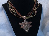 Copper Dragonfly w/Swarovski Tail
5-Strand Suede Leather
Glass Beads, Copper Beads, Red Bronze Bail
Dragonfly floats on coppery green leaf
SOLD!