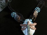 5-Strand black lace leather
Eclectic mix of beads
Teal, white & copper lampworked glass leaf
Over 60 Swarovski crystals adorn the tail of the copper dragonfly
SOLD!