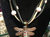 5-Strand Suede Lace Leather
Copper Dragonfly w/ over 60 Swarovski Crystals in Siam, Peridot, Topaz, Absolute 
59x35mm green lampworked glass leaf
S/N NCDLS5CL0004
Available: Contact Us